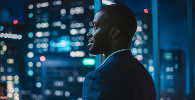 Man looking out window.