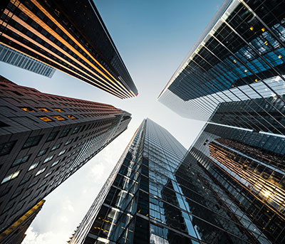 A series of office towers, viewed from below.