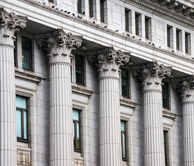 A series of architectural columns on the exterior of a financial institution.