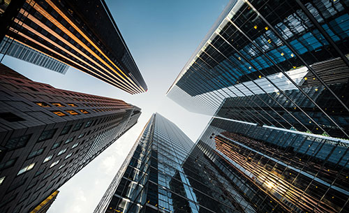 A series of office towers, viewed from below.