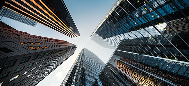 A series of office towers, viewed from below.